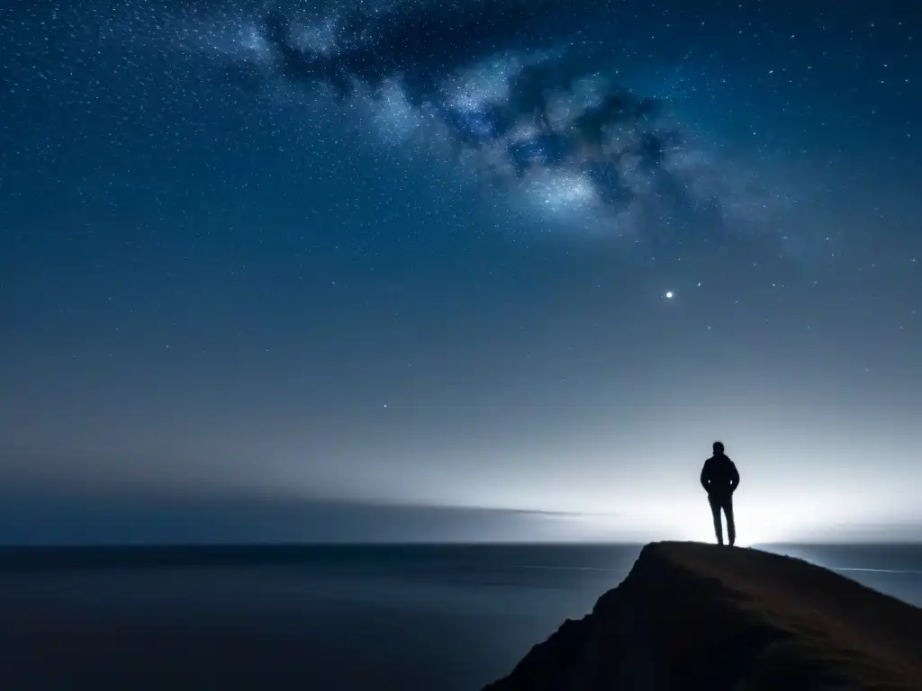 Figura solitaria en acantilado contempla vasto mar bajo cielo estrellado